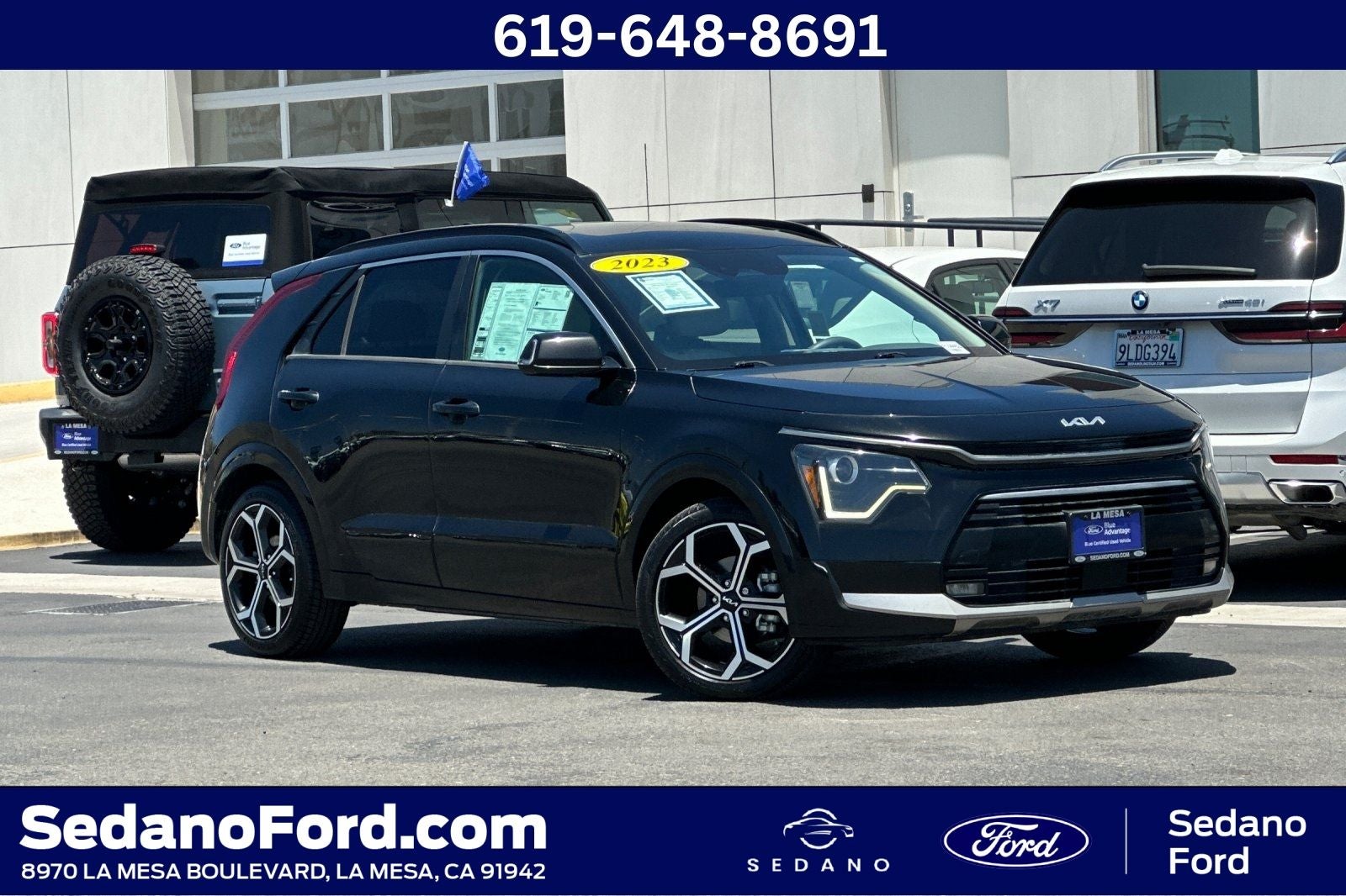 2023 Kia Niro EX Touring in Aurora Black Pearl — front three-quarter view
